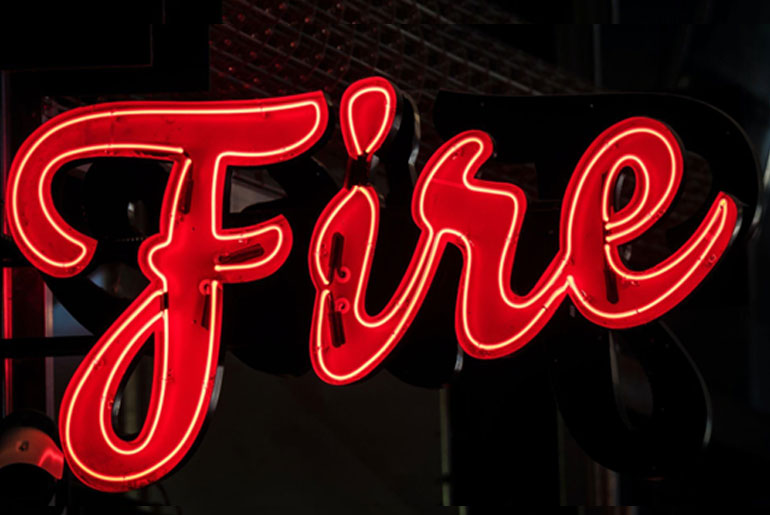 The word ‘fire’ in red neon text against a street background