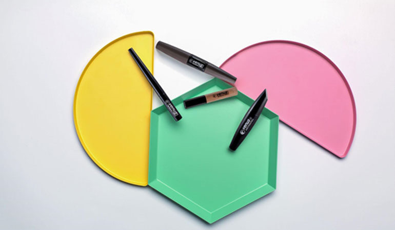 Yellow semicircle with a green hexagon and pink semicircle, covered in four pens against a white background